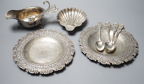 A late Victorian silver butter shell, a later silver sauceboat, seven assorted silver teaspoons including Scottish and two continental white metal dishes(a.f.), gross 16.5oz.